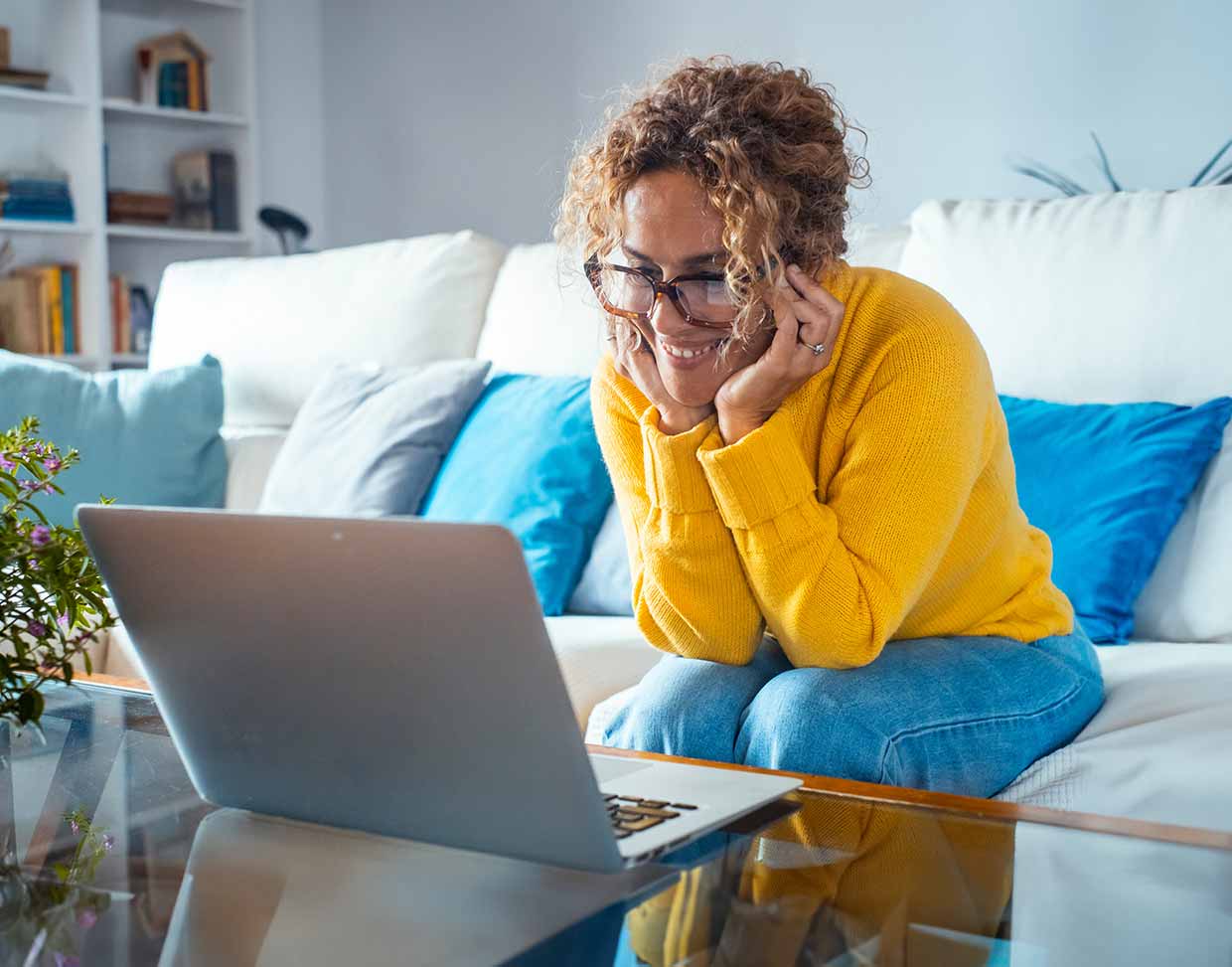 Woman using laptop on coffee table