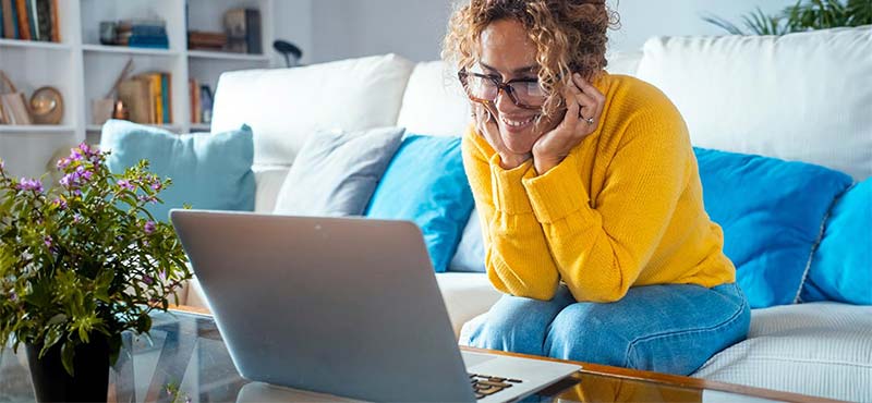 Woman using laptop on coffee table